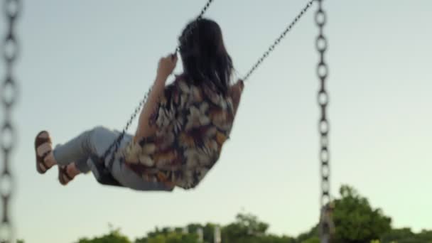 Girl swings in park — Stock Video