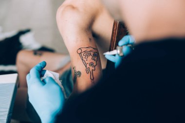Hipster man gets pizza tattoo clipart
