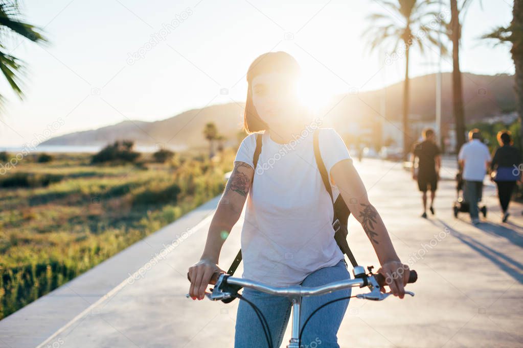 Attractive woman rides on bicycle  