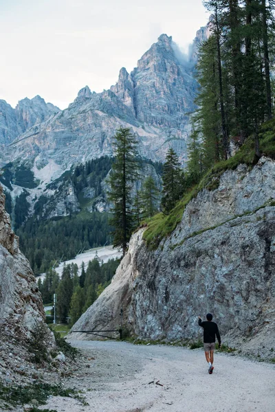 Explorer male figure in between mountains