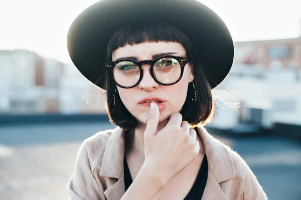 Serious fashion model touches dry lips — Stock Photo, Image