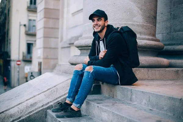 Genç üniversite merdiven üstünde oturuyor