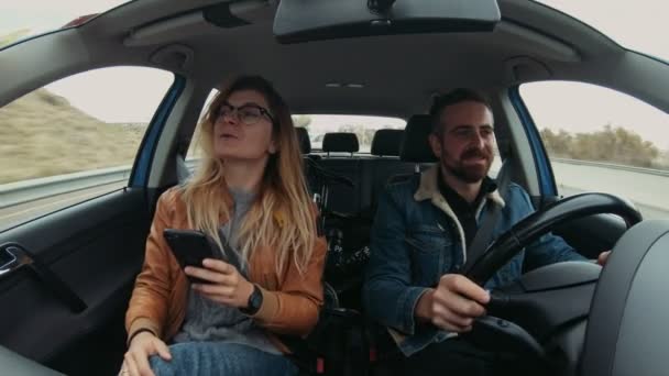 Cute hipster couple drives car at roadtrip — Stock Video
