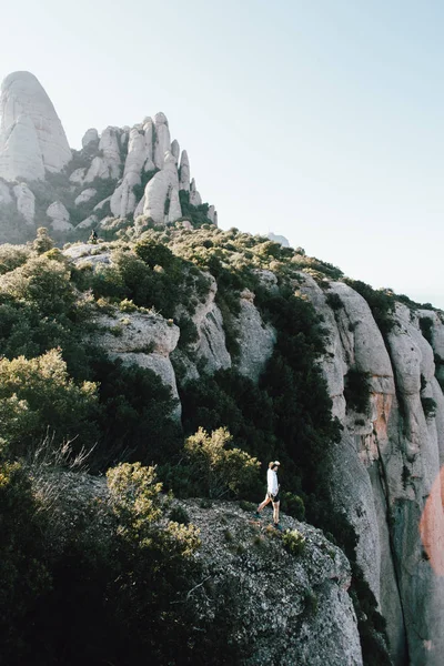 Tiny figure or athlete, adventurer, runner or sportsman in middle of amazing epic landscape with mountains and cliffs around, national park nomad lifestyle, travel inspiration