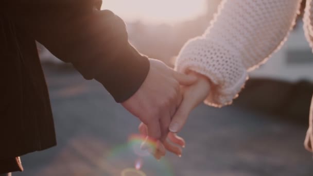 Couple holds hands in sunset light Stock Video