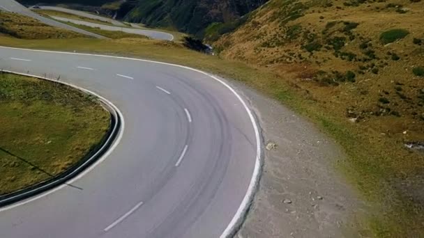 Ciclista de carretera sube por la puesta de sol montaña switchbacks — Vídeos de Stock