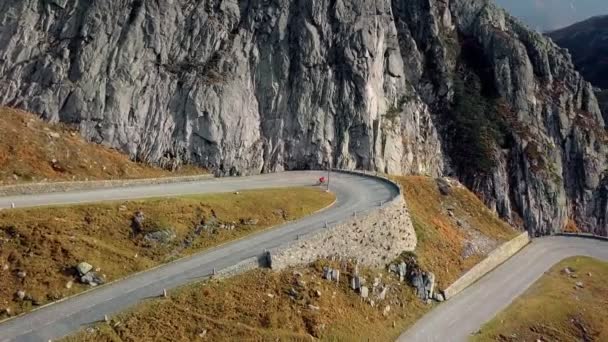 Cycliste de route grimpe vers le coucher du soleil montagnes switchbacks — Video