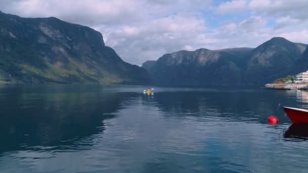 Aerial drone shot of yellow kayak in fjord water — Stock Video