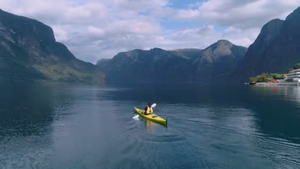 Aerial drone shot of yellow kayak in fjord water — Stock Video