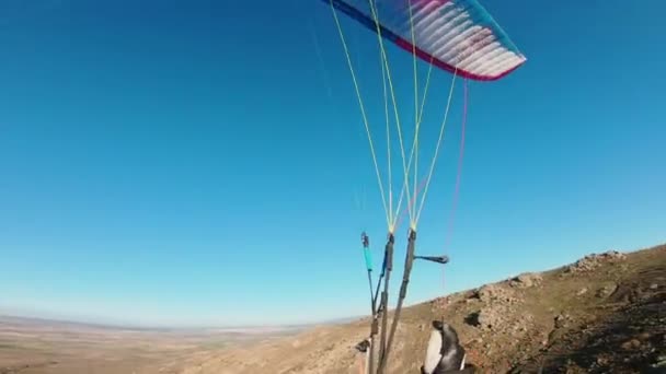 POV shot of paraglider make love heart hand sign — Stock Video