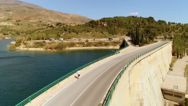 Ευτυχισμένος τουρίστας τρέχει στη γέφυρα κοντά στα βουνά — Αρχείο Βίντεο