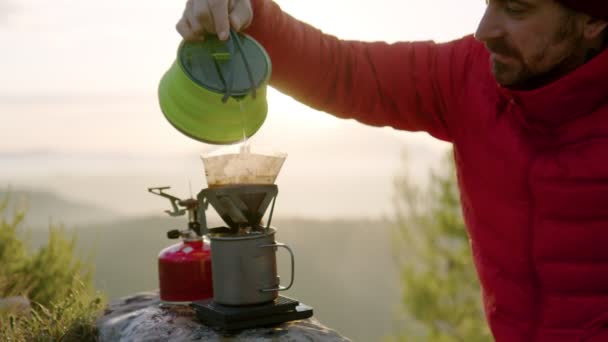 Man traveller makes coffee in camping gear — Stock Video