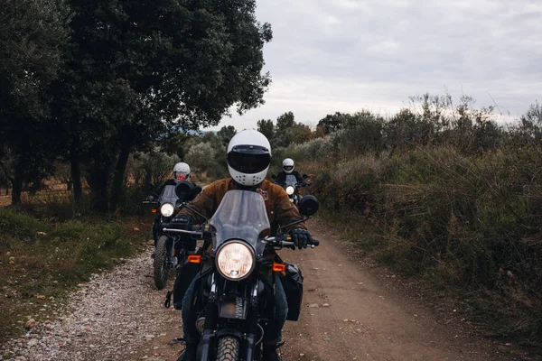 Group of motorcycle bikers on gravel dirt road