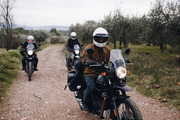 Group of motorcycle bikers on gravel dirt road
