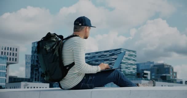 Hipster man work on laptop in business district — Stock Video