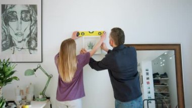 Yaratıcı çift modern dairede resim yapıyor.