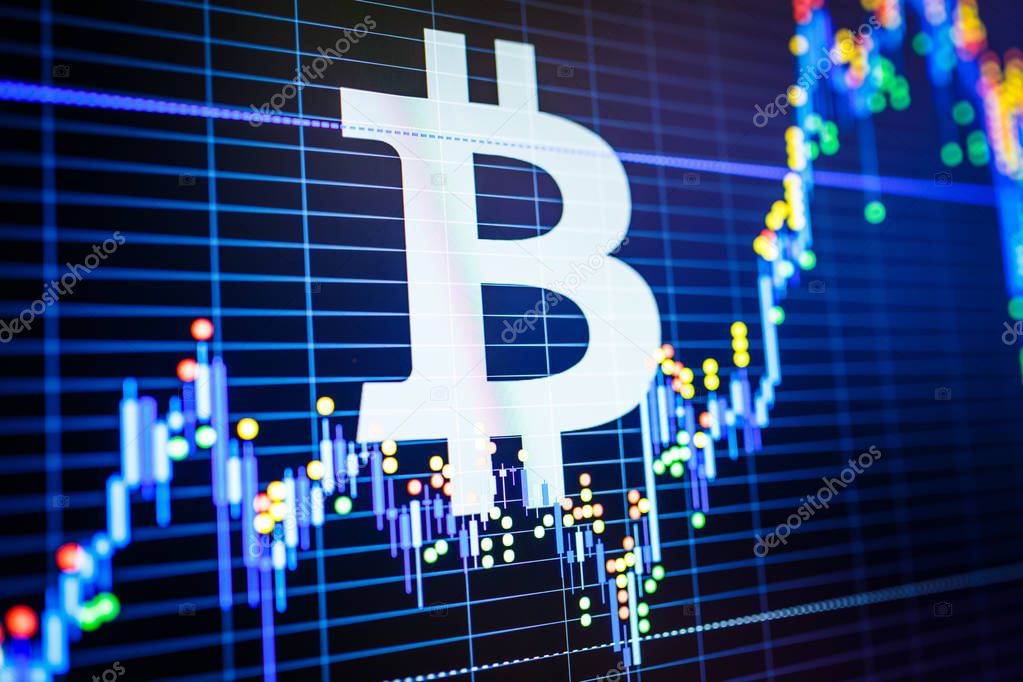Data analyzing in exchange stock market: the candle chars on display. Analytics price change cryptocurrency BTC to USD (Bitcoin / US Dollar), the most popular pair in the world. Big Bitcoin logo.