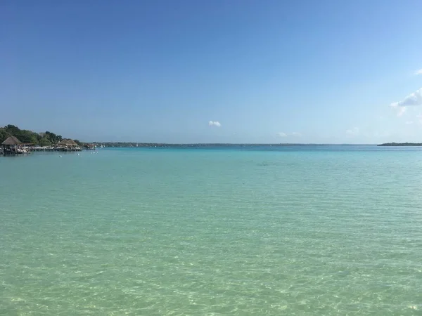 Beautiful ocean view with clean blue turquoise water, sunny day. Amazing background of island, Caribbean, Lagoon Bacalar. Calm secluded place without people, paradise