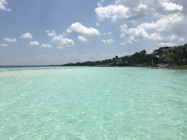 Beautiful ocean view with clean blue turquoise water, sunny day. Amazing background of island, Caribbean, Lagoon Bacalar. Calm secluded place without people, paradise