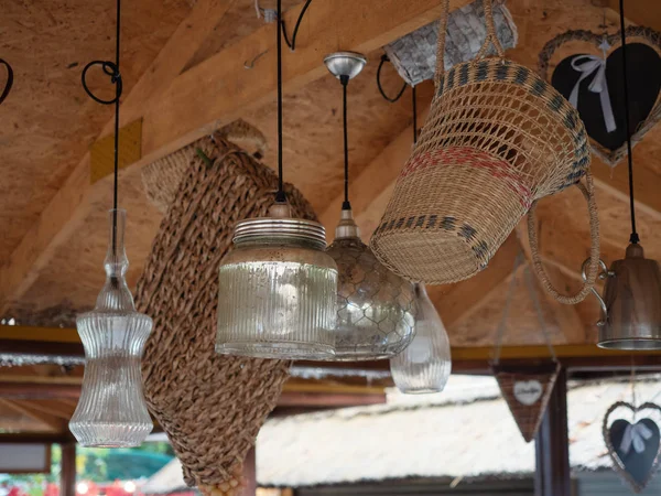 Decorative lamps and baskets hang on the ceiling