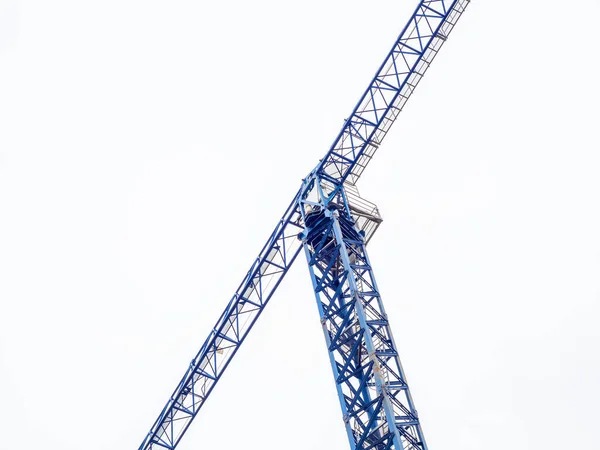 Hohe blaue Turmdrehkran für den Bau von Häusern auf einem bewölkten Himmel Hintergrund — Stockfoto