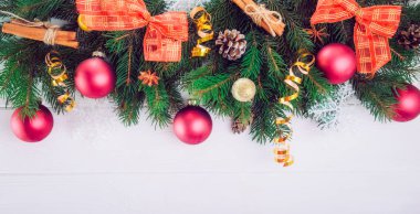 Noel arka plan ile çam dalları, yılbaşı dekor, oyuncak ve baharat beyaz ahşap zemin üzerinde. Üstten Görünüm kopya alanı ile. Seçici odak, geniş başlık biçimi