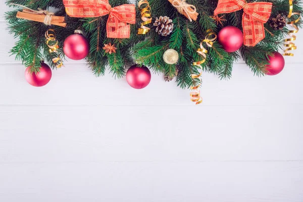 Fondo de Navidad con ramas de abeto, decoración de año nuevo, juguetes y especias en el fondo de madera blanca. Vista superior con espacio de copia. Enfoque selectivo , — Foto de Stock