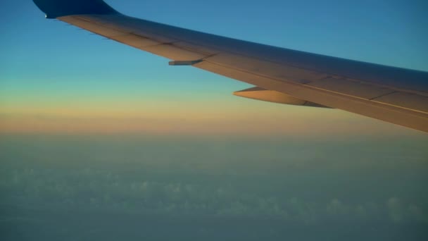 飛行機からの眺め。白い雲と青い空。4 k の解像度。高い高度で飛行します。対流圏。10 に 12 キロの高さで飛行。飛行中の飛行機の翼。美しい景色 — ストック動画