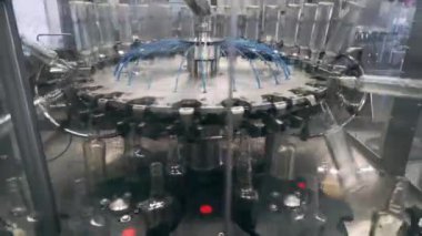 Spill of alcohol in glass bottles at the plant. Conveyor belt with glass bottles. Shop the spillage of alcoholic beverages. Rinsing bottles. The production process of alcoholic beverages. 4K res.