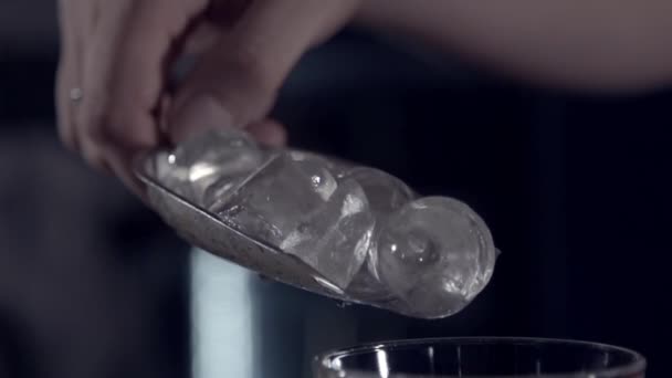 Dropping ice into a wineglass in slow motion — Stock Video