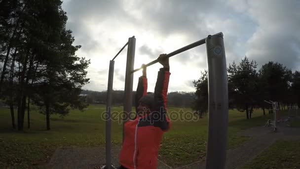 Woman Hang on Horizontal Bar Stretching Back — Stock Footage Woman Hang on Horizontal Bar Stretching Back Royalty Free Stock Video