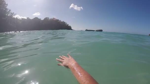 Жіночий руку, торкаючись блискучі морської води — стокове відео