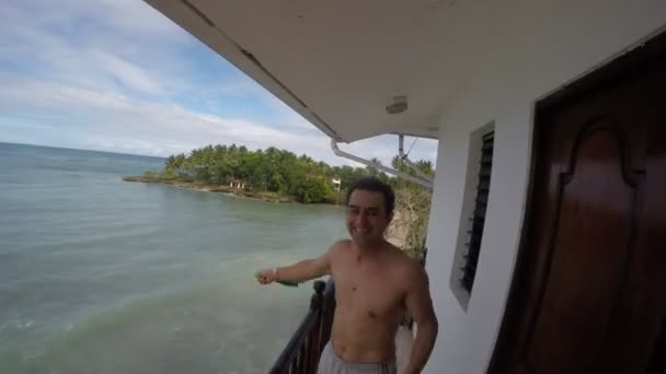 Happy Crazy Man Jumping on the Balcony and Shaking T-Shirt — Stock Video