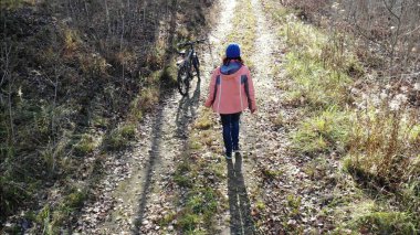 Cyclist Woman Riding On Bicycle On Countryside Road in autun forest, Having Fun And Enjoying Life