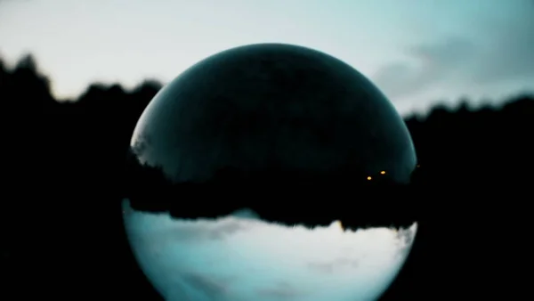 Getting dark, dusk, clouds passing reflection in crystal ball, horror scene, time lapse