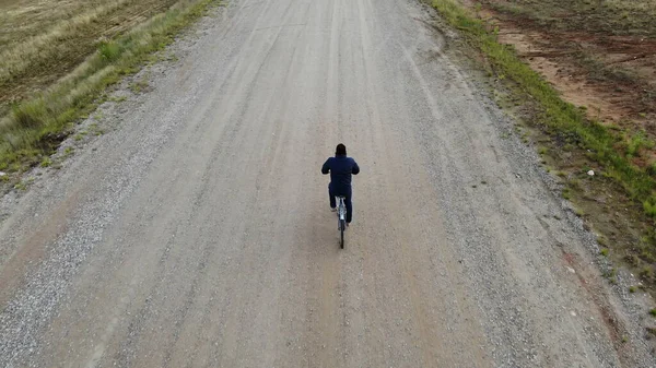 cycling road bike, bicycle rider from top, aerial view, shot from above, man cyclist on empty road