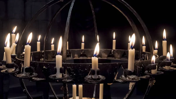 Nuremberg 2019. Candles lit in a wrought iron candle holder inside the Frauenkirche. August 2019 in Nuremberg