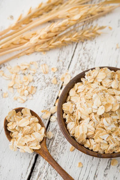 Raw rolled oats, oat flakes and oat spikes or spikelets