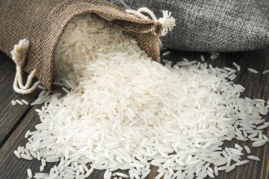 Raw Basmati rice grits in small cloth sacks clipart