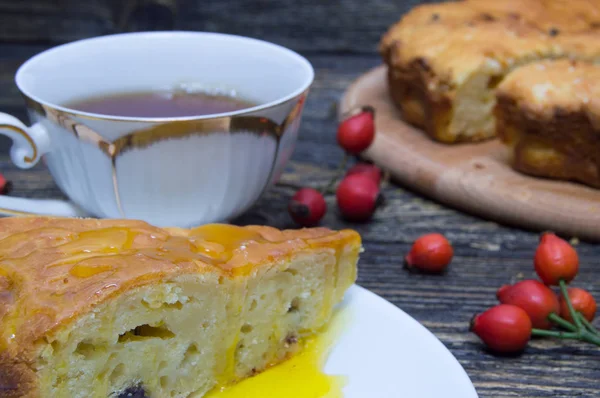 Homemade pie with honey, cup tea with rosehip berry