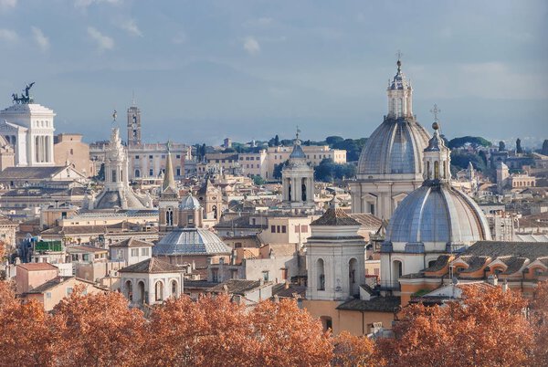 Rome historic center autumn skyline with ancient domes, spires and towers at sunset