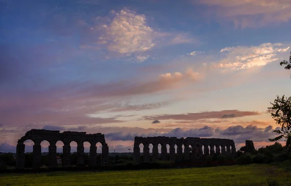 Roman aqueduct ruins at sunset