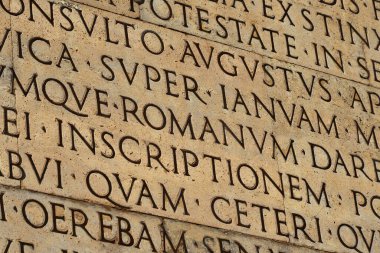 Latin ancient language and classical education. Inscription from Emperor Augustus famous Res Gestae (1st century AD), with the word Romanum in the center clipart