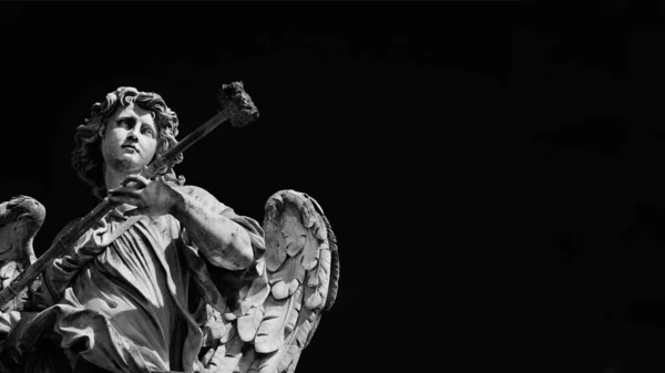 Angel marble statue with sponge, a 17th century baroque masterpiece on Holy Angel Bridge in Rome (Black and White with and copy space)