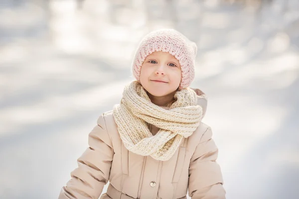 Portrait on a little girl in a beige warm clothes in winter — Stock Photo, Image