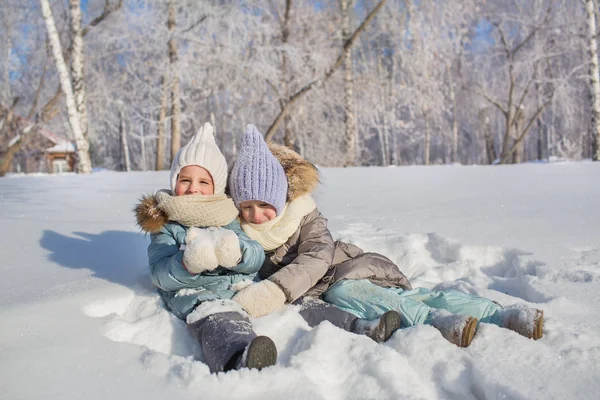 Due bambine giocano e si abbracciano in un inverno — Foto Stock