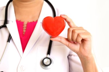 Kadın doktor güzel kırmızı kalp şekli tutan eller