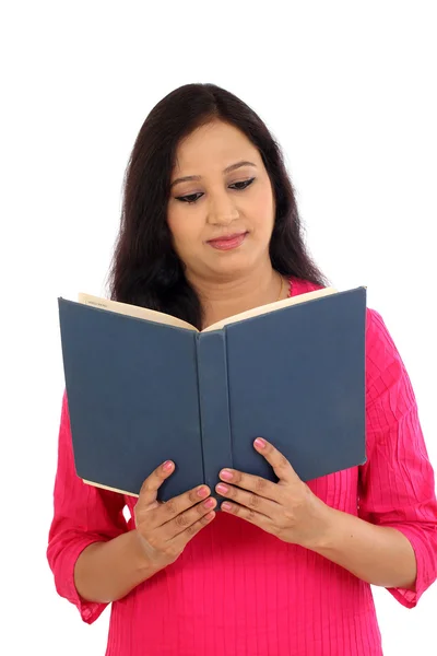 Young female student reading a text book against white backgroun — Stock Photo, Image