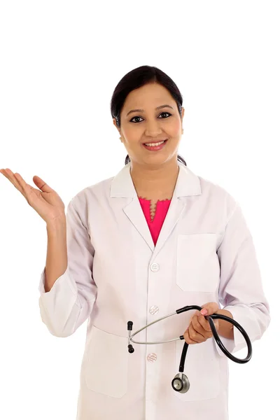 Young doctor woman presenting and showing copy space — Stock Photo, Image