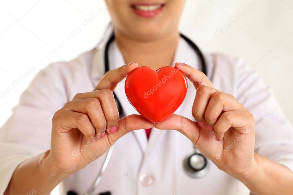 Female doctor hands holding a beautiful red heart shape